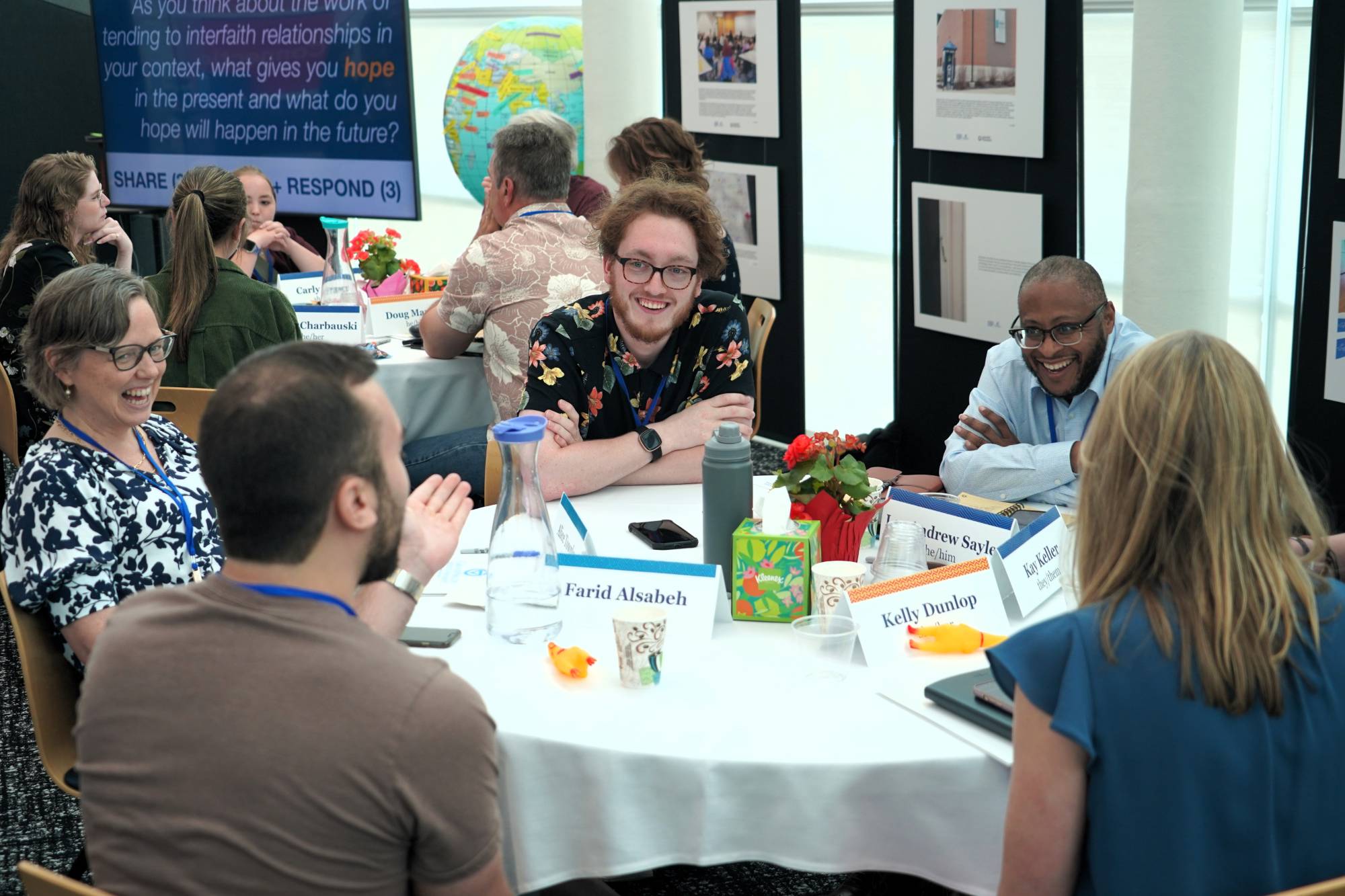 Group of people engaged in conversation around a table